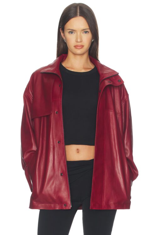 Front view of a dark red leather trench jacket worn unzipped and open over a black crop top, displaying silver zipper hardware, snap buttons, and folded lapels.