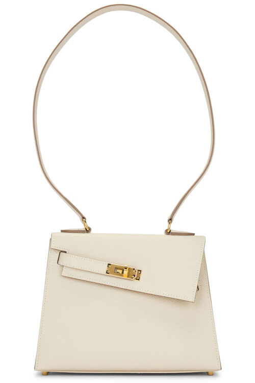Cream-colored trapezoidal handbag with top handle and gold turn-lock clasp