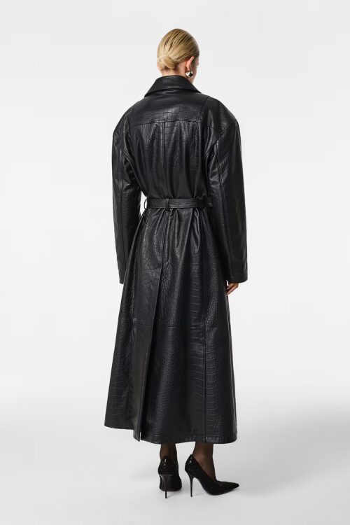 Rear studio shot of an ankle-length black croc-embossed leather coat showing drop shoulders, cinched belted waist, structured back yoke, and deep back vent seam.