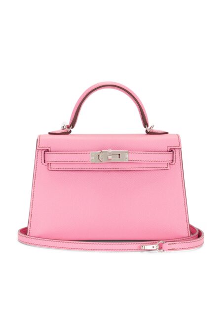 Front view of a structured pink calfskin leather handbag with a top handle, removable shoulder strap, and polished silver-tone turn-lock hardware displayed on a clean white background.