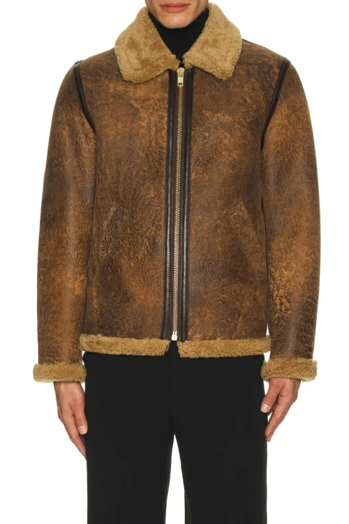 Model wearing a fully zipped distressed brown leather flight jacket featuring a plush tan sheepskin shearling collar, waist trim, sleeve cuffs, and dark brown leather taped seams.