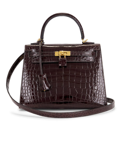 Front view of a structured dark brown shiny alligator leather handbag with polished gold-tone hardware, top handle, leather clochette, detachable shoulder strap, and elegant craftsmanship displayed on a white background.