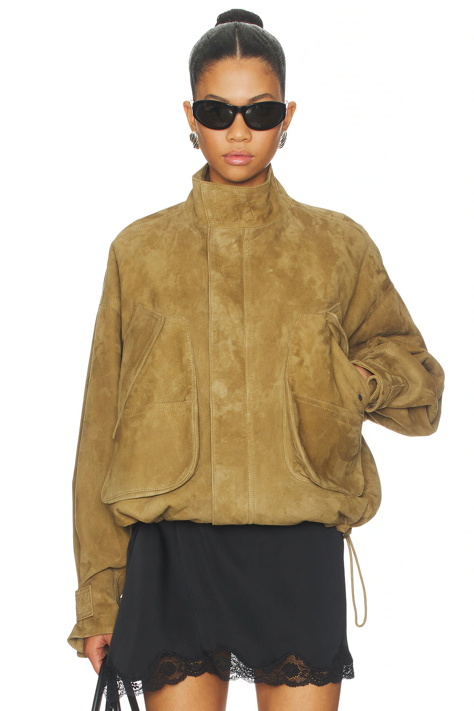 Front view of a model wearing a premium heavyweight brown suede jacket with a high collar, zip closure, large front pockets, and cinch-cord details.