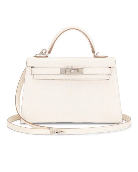 White matte alligator leather Sellier handbag shown from the front with a structured top handle, removable shoulder strap, signature turn-lock closure, and polished silver-tone hardware on a clean white background.