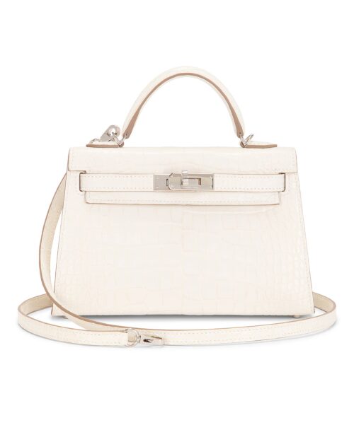 White matte alligator leather Sellier handbag shown from the front with a structured top handle, removable shoulder strap, signature turn-lock closure, and polished silver-tone hardware on a clean white background.
